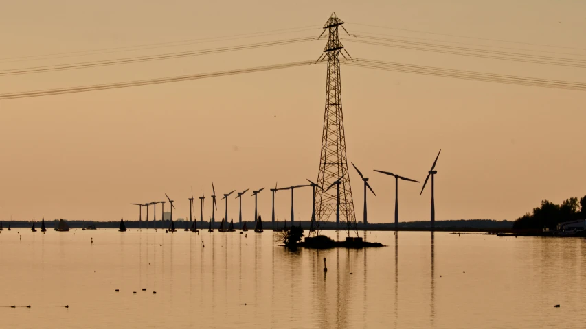 a large body of water with windmills in the background, a picture, by Jesper Knudsen, hurufiyya, powerlines, silhouetted, brown