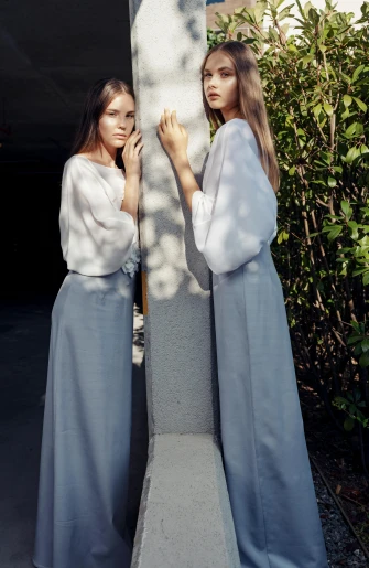 a couple of women standing next to each other, inspired by Silvia Pelissero, instagram, cropped wide sleeve, silver，ivory, pale blue, collection