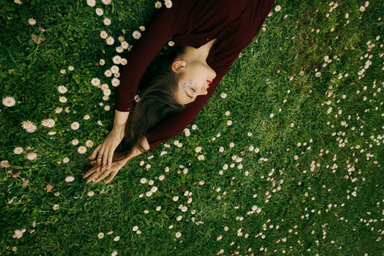 a woman laying in a field of daisies, inspired by Elsa Bleda, pexels contest winner, land art, top down shot, young woman looking up, 15081959 21121991 01012000 4k, digitally enhanced