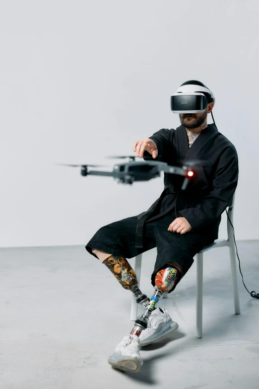 a man sitting on a chair with a remote control, a hologram, unsplash, renaissance, flying drones, wearing japanese techwear, trending on dezeen, prostheses