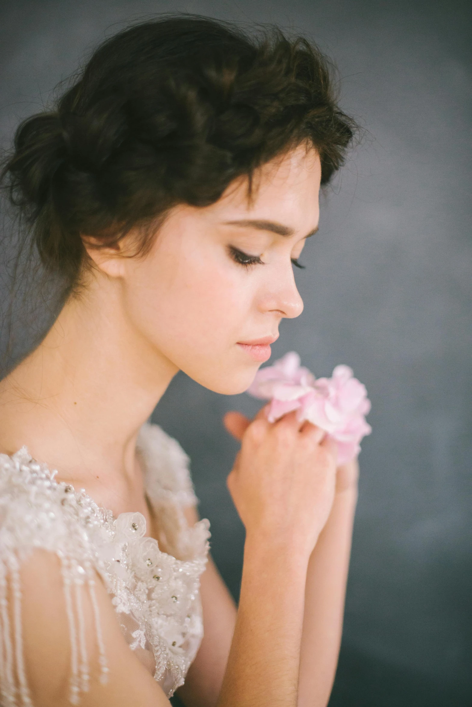a woman in a wedding dress holding a flower, by Eizan Kikukawa, unsplash, romanticism, her face is a mauve flower, oona chaplin, studio lighting”, profile shot