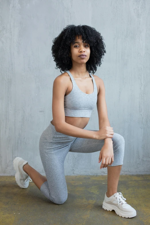 a woman in a sports bra top and leggings, inspired by Christen Dalsgaard, trending on pexels, renaissance, gray canvas, curls, ready to model, yzy gap