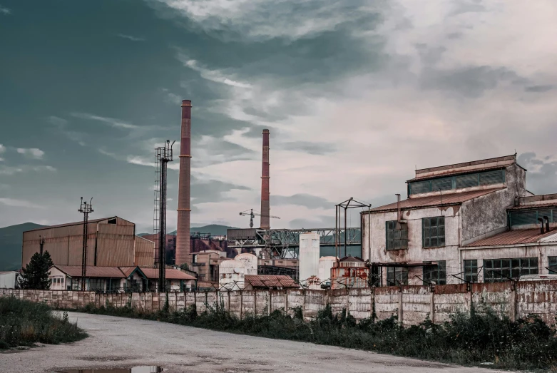 a red fire hydrant sitting on the side of a road, a colorized photo, inspired by Elsa Bleda, pexels contest winner, renaissance, chemical plant, chimneys on buildings, steel mill, turkey