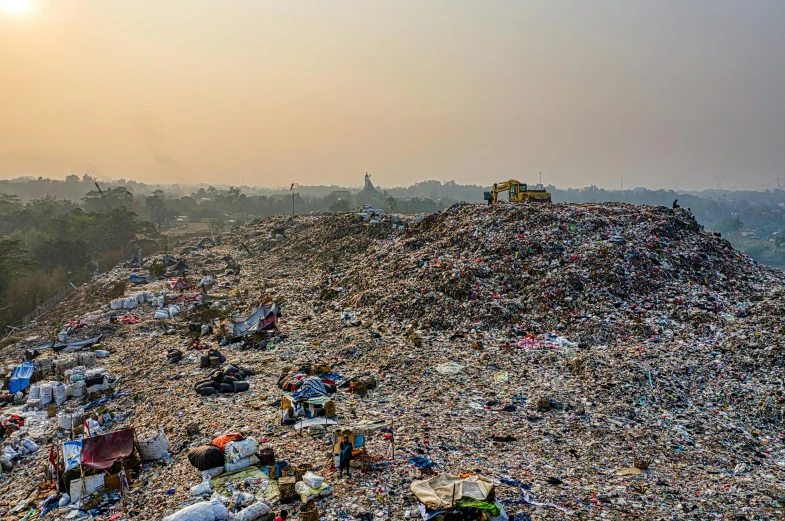 a large pile of garbage sitting on top of a hill, unsplash, plasticien, bangladesh, profile image, morning golden hour, dezeen