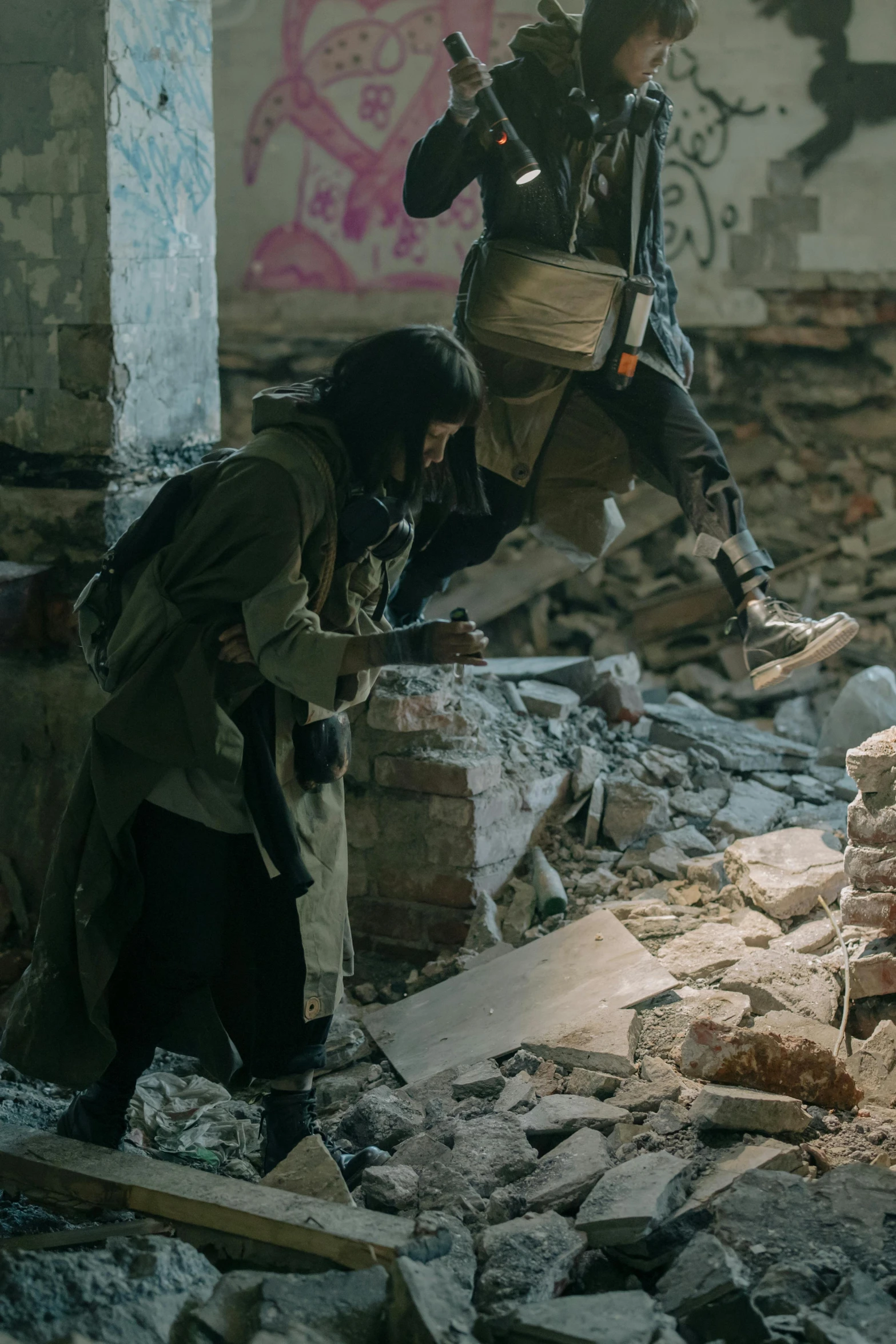 a couple of men standing on top of a pile of rubble, by Ilya Ostroukhov, unsplash contest winner, graffiti, costumes from peaky blinders, firing it into a building, action shot girl in parka, ( ( theatrical ) )