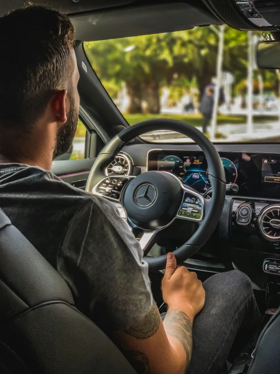 a man sitting in the driver's seat of a car, mercedez benz, thumbnail, profile image, taken in 2 0 2 0