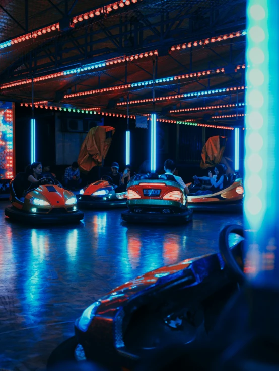 a group of bumper cars parked inside of a building, cinematic blue lighting, profile image, low quality photo, thumbnail