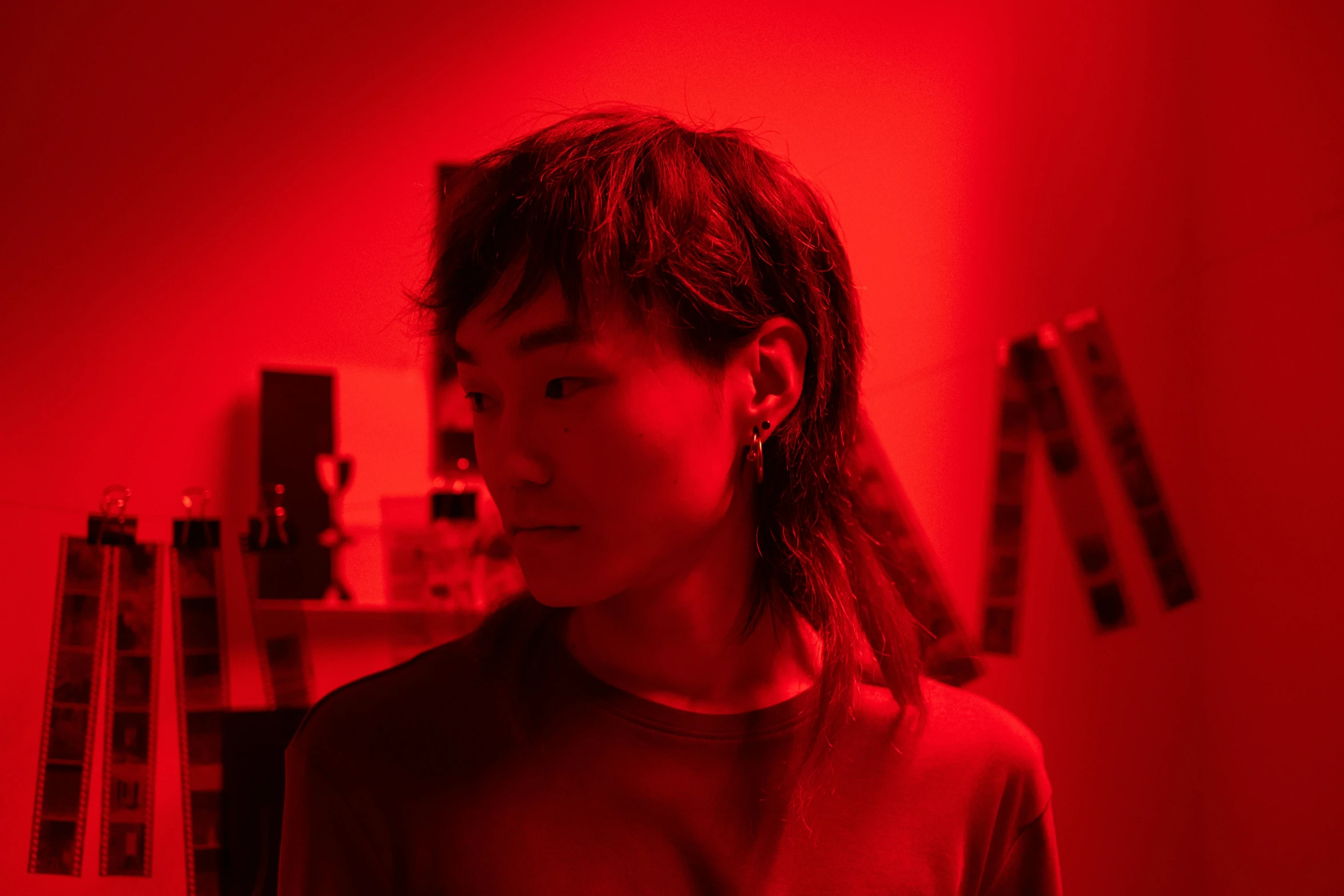 a woman standing in front of a red light, inspired by Nan Goldin, pexels contest winner, massurrealism, yihao ren, stood in a lab, sideburns, red leds