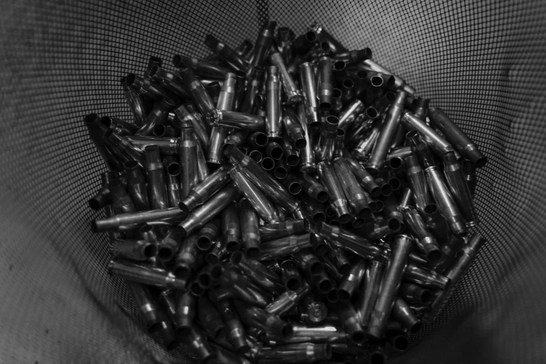 a black and white photo of a pile of bullet casings, by Daniel Lieske, swirly tubes, wip, desaturated!, dark plastic