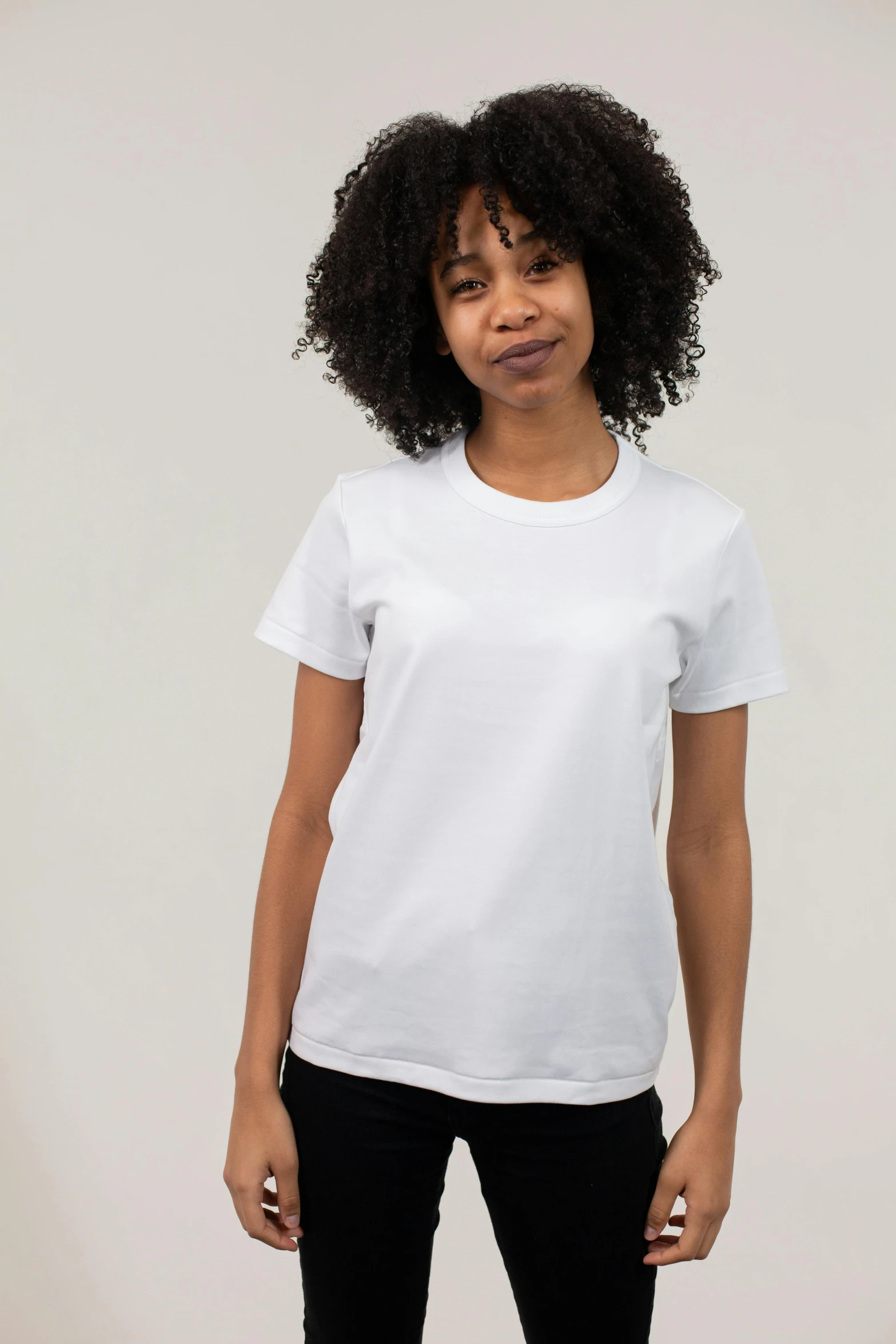 a woman wearing a white shirt and black pants, dressed in a white t shirt, profile image, sport t-shirt, in front of white back drop