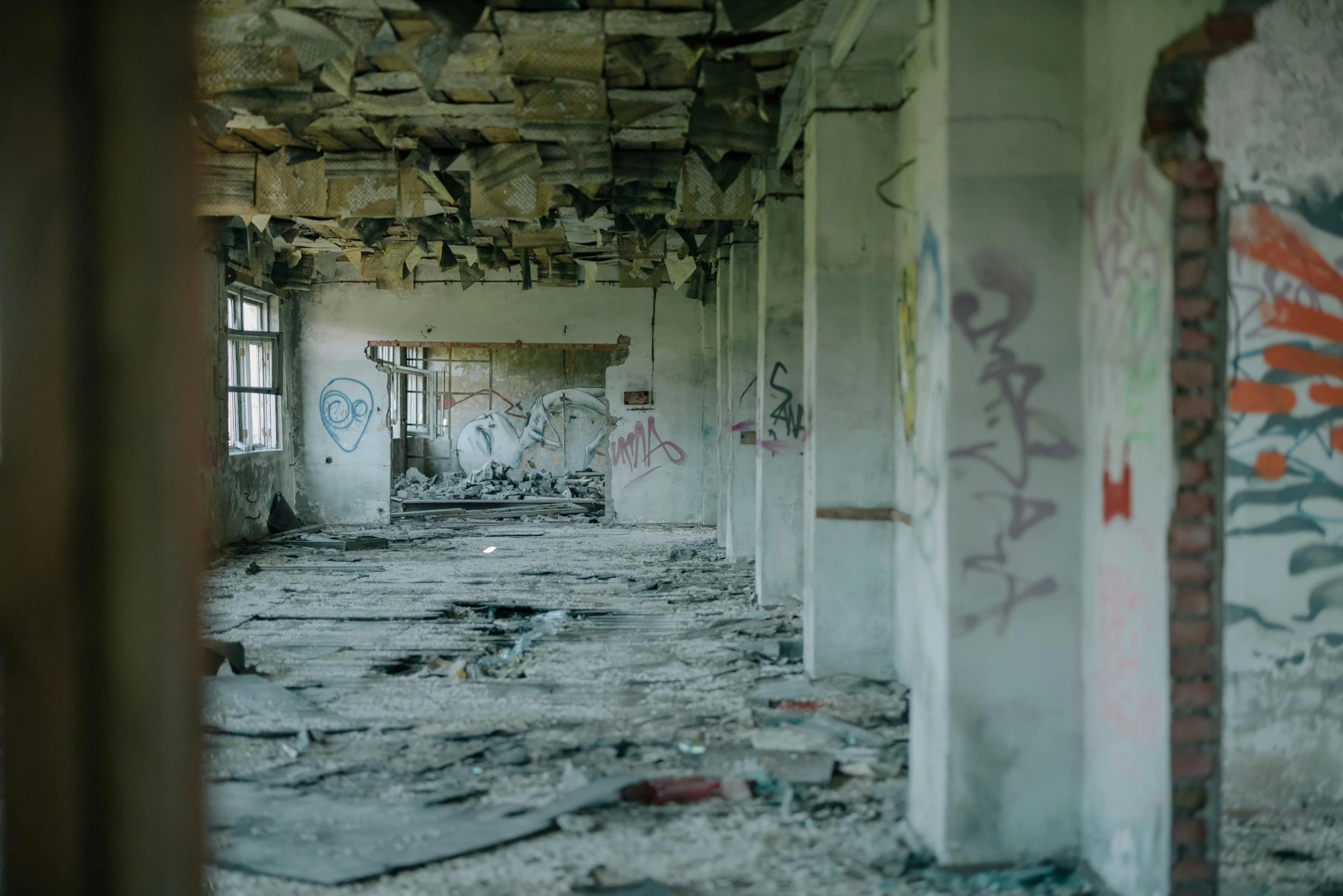 a run down building with graffiti on the walls, unsplash contest winner, debris on the floor, ( apocalyptic ) 8 k, faded and dusty, nuclear aftermath