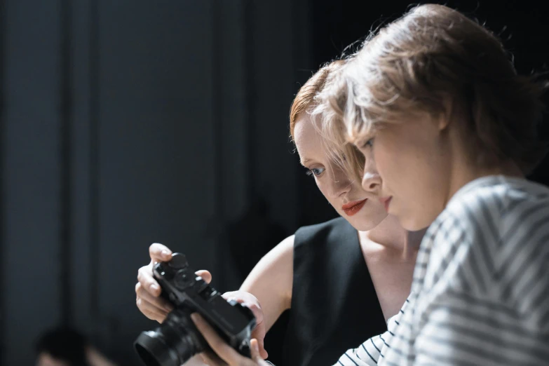 a woman holding a video game controller next to another woman, a picture, by Emma Andijewska, unsplash, visual art, hasselblad x 1 d, posing elegantly over the camera, planning, avatar image