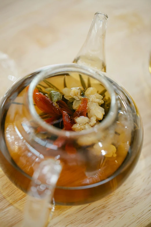 a tea pot sitting on top of a wooden table, olive oil, infused, slide show, uncropped