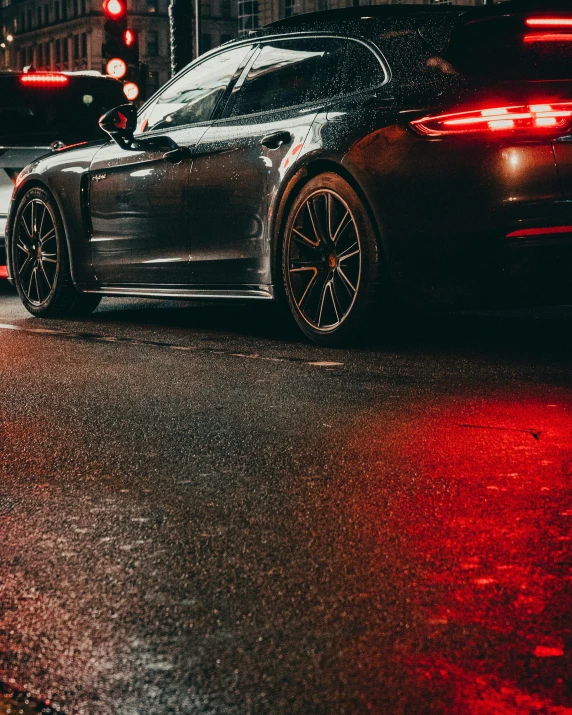 a porsche parked on a city street at night, by Adam Marczyński, pexels contest winner, gradient red to black, wet asphalt, thumbnail, zoomed in