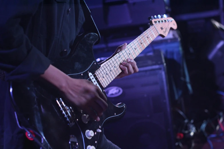 a close up of a person playing a guitar, pexels contest winner, blacks and blues, rectangle, band, multi chromatic