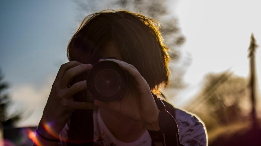 a person taking a picture with a camera, a picture, pexels contest winner, backlit portrait, reflective lens, shot from below, today\'s featured photograph 4k