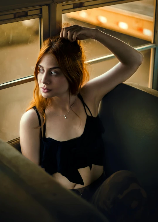 a woman sitting on a train looking out a window, inspired by Nan Goldin, featured on reddit, renaissance, katherine mcnamara inspired, in a black betch bra, christina hendricks, square