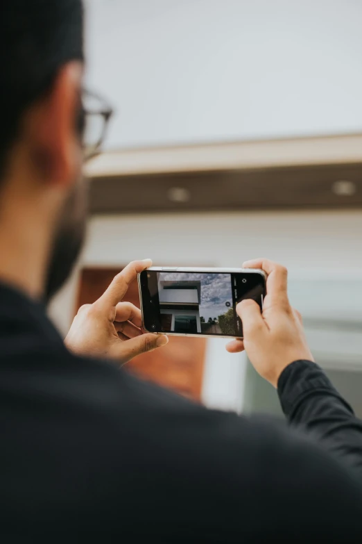 a man taking a picture with his cell phone, a picture, pexels contest winner, home video footage, shot from roofline, avatar image, mobile learning app prototype