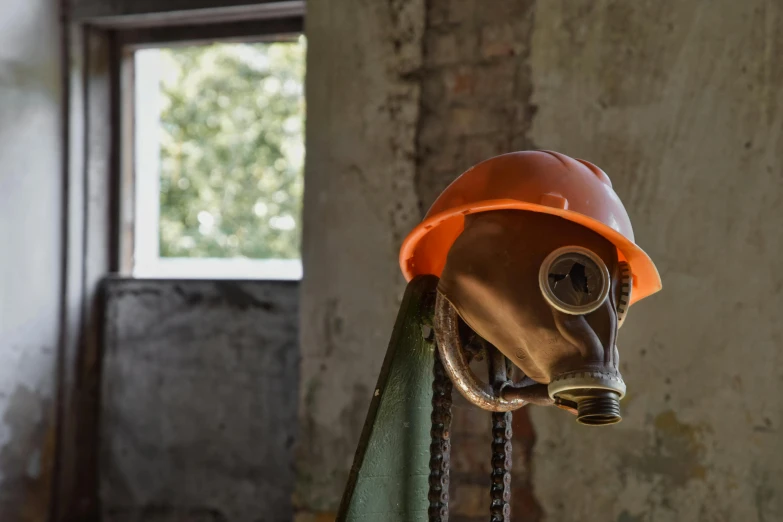 a close up of a person wearing a gas mask, by Eglon van der Neer, pexels contest winner, modernism, construction site, in a old house. hyper realistic, orange head, soviet - era