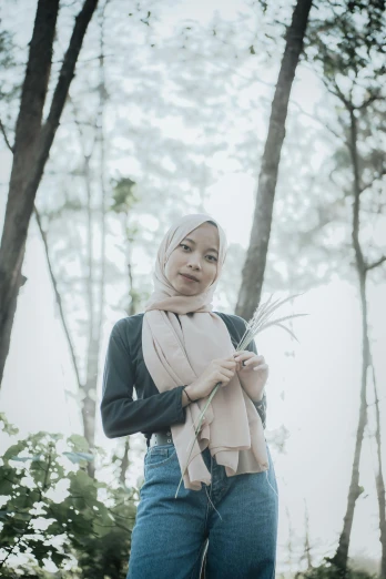 a woman standing in the middle of a forest, inspired by Ren Renfa, hurufiyya, wearing a scarf, malaysian, 🤤 girl portrait, with a straw