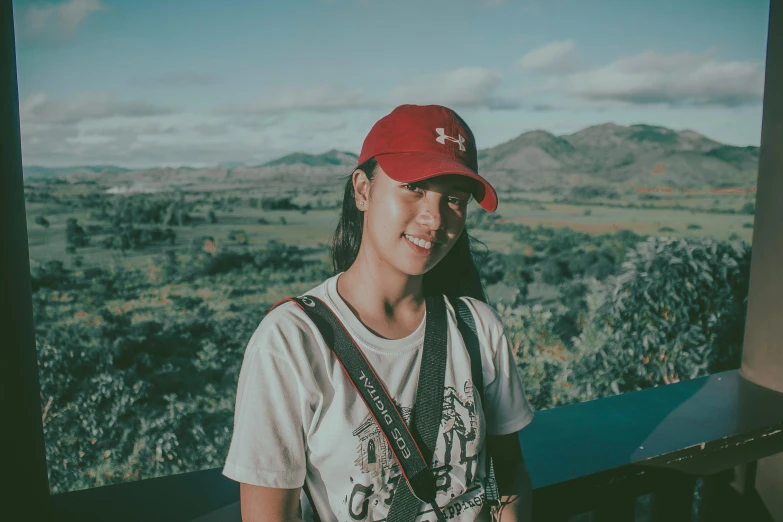 a woman wearing a red hat posing for a picture, scenic view, background image, wearing a baseball cap, andrew thomas huang