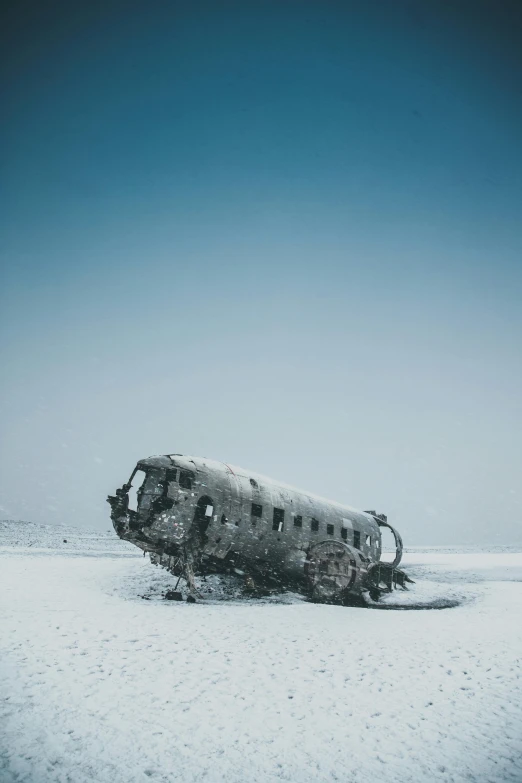 a plane sitting on top of a snow covered field, unsplash contest winner, surrealism, destroyed ship, ice dust, flying mud, van