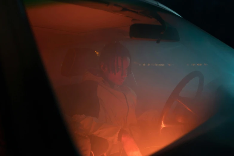 a man sitting in the driver's seat of a car, an album cover, inspired by Elsa Bleda, pexels contest winner, conceptual art, trippie redd, foggy neon night, photography of todd hido, instagram post