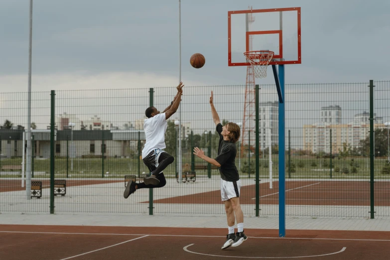 a couple of men playing a game of basketball, by Matija Jama, pexels contest winner, incoherents, square, hd footage, mid air, 8k 28mm cinematic photo