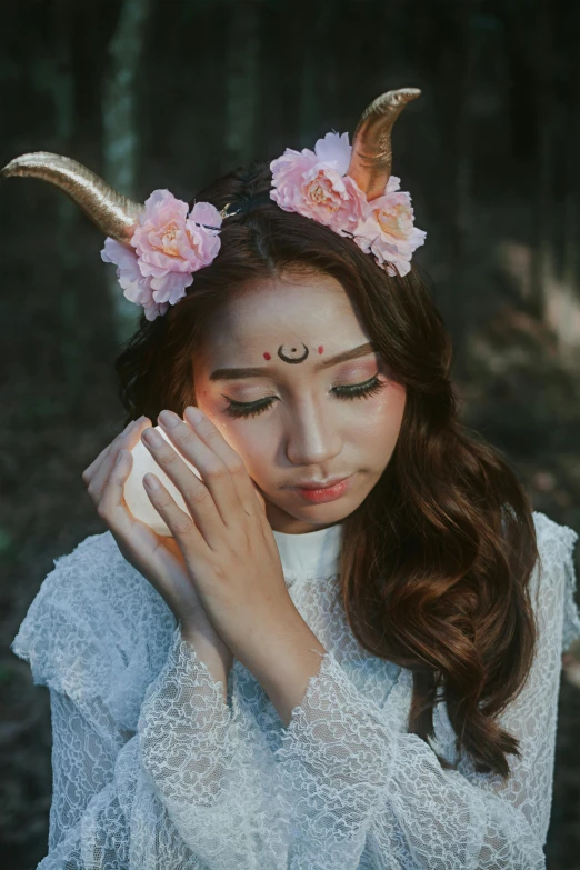 a woman with horns and flowers on her head, inspired by Luo Mu, trending on pexels, aestheticism, ulzzang, satyr, instagram picture, south east asian with round face