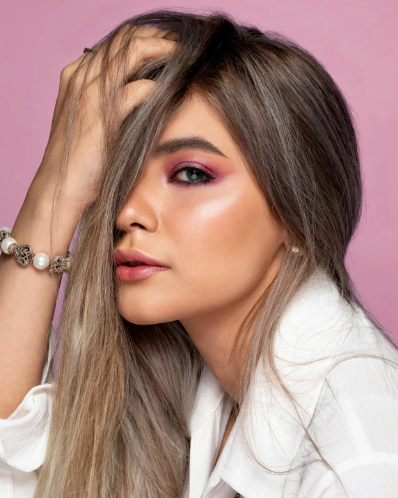 a woman with long hair wearing a white shirt, a colorized photo, inspired by Natasha Tan, trending on pexels, dau-al-set, eyeshadow, doing a sassy pose, detailed product image, pink hue