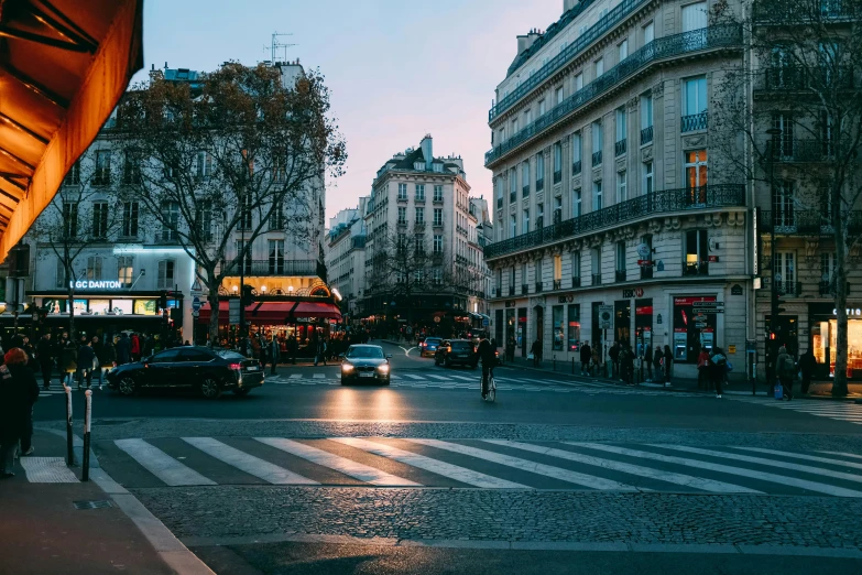 a street filled with lots of traffic next to tall buildings, pexels contest winner, paris school, crosswalks, early evening, square, 1 2 9 7