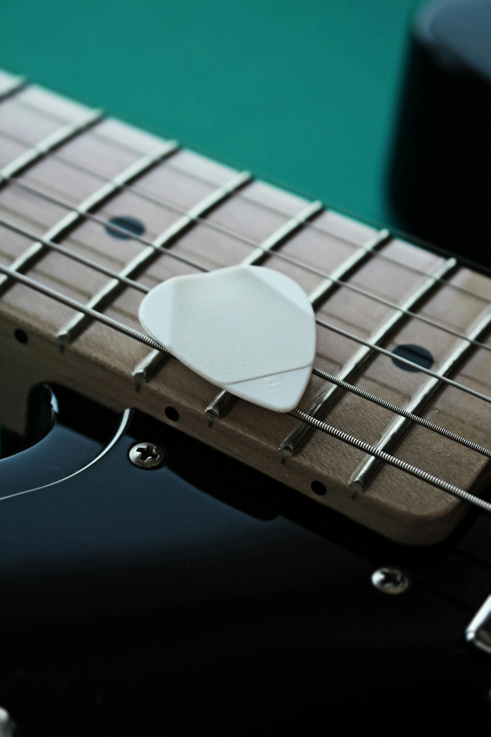 a close up of a guitar with a guitar pick, white ceramic shapes, medium sensor, clean line, heartstone