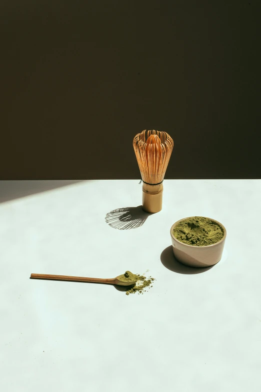 a bowl of matcha next to a whisk of matcha, inspired by Inshō Dōmoto, renaissance, curated collection, made of bamboo, image