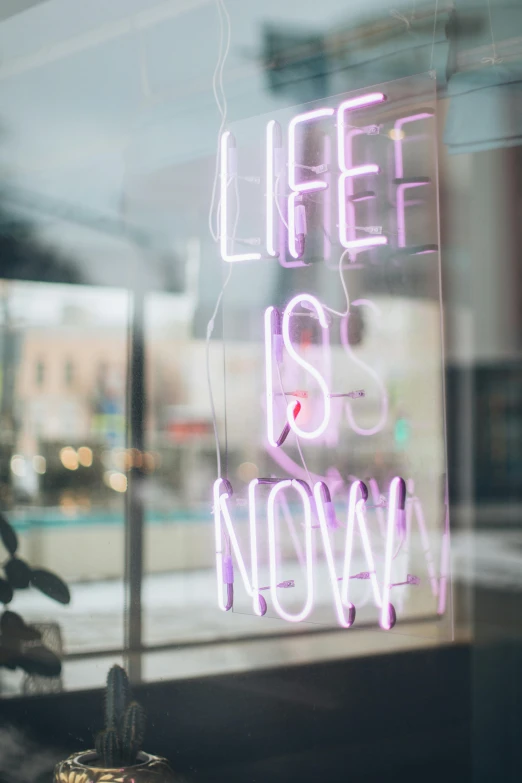 a neon sign that says life is now, unsplash contest winner, shopwindows, instagram story, low quality photo, lifestyle