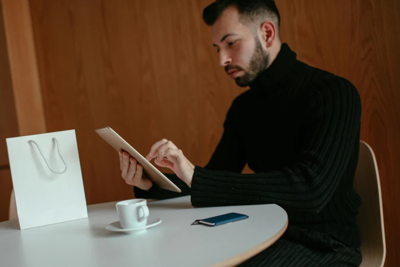 a man sitting at a table using a tablet computer, a portrait, by Sebastian Vrancx, pexels contest winner, wearing turtleneck, avatar image, restaurant menu photo, with a white mug