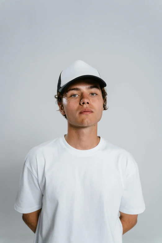 a man in a white shirt and a white hat, reddit, in front of white back drop, trucker hat, dylan kowalski, white on black