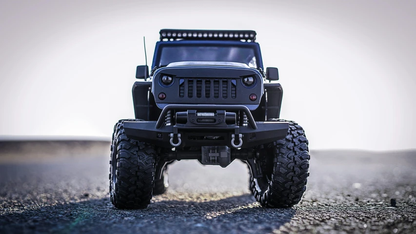 a toy jeep sitting on top of a gravel road, slick leds, matte black, ultra high face symmetry, jk