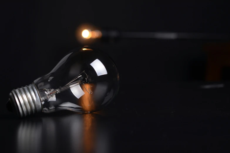 a light bulb sitting on top of a table, experimental studio light, awkward situation, gas lighting, electrical
