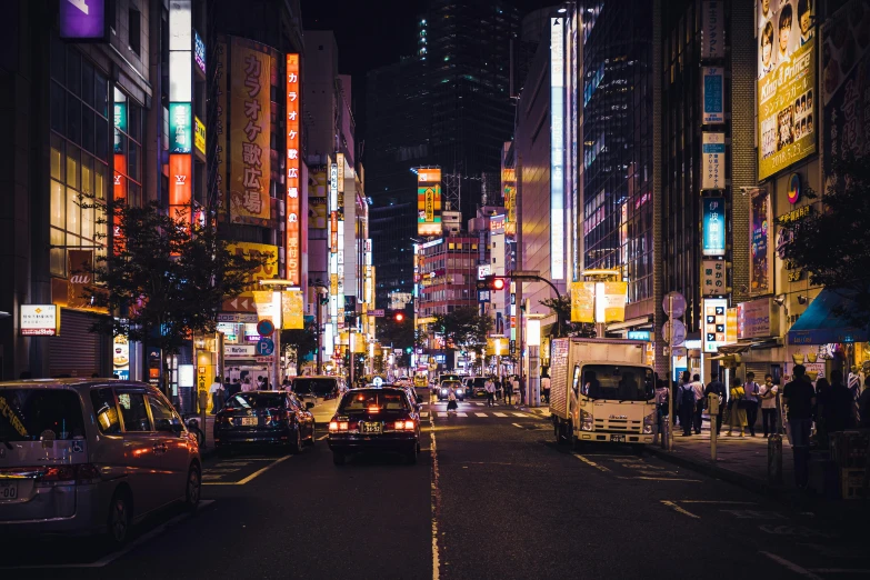 a city street filled with lots of traffic at night, inspired by Kanō Hōgai, pexels contest winner, ethnicity : japanese, 80's japanese photo, streetscape, fujifilm”