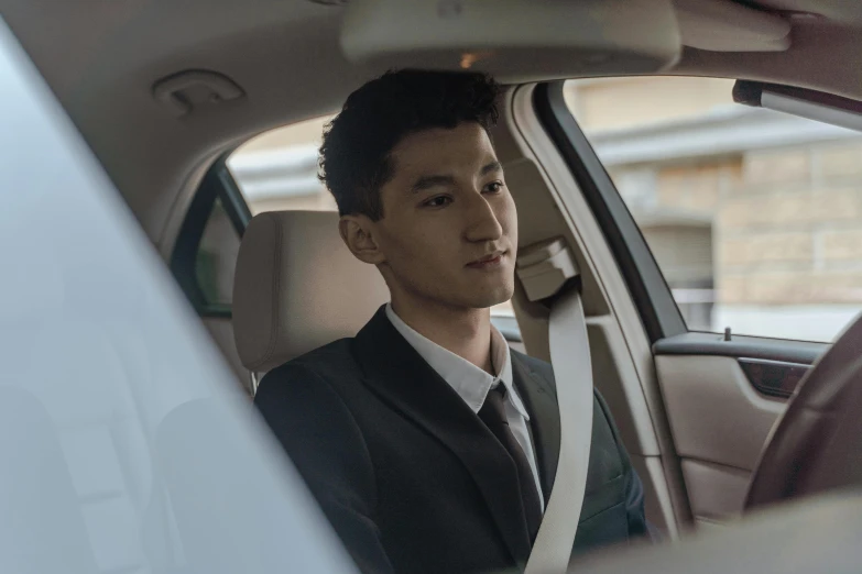 a man in a suit sitting in a car, ryan jia, avatar image, commercial, wonbin lee