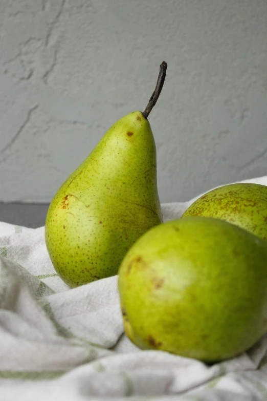 three green pears sitting on a white cloth, award - winning crisp details, fan favorite, fruit basket, chilean