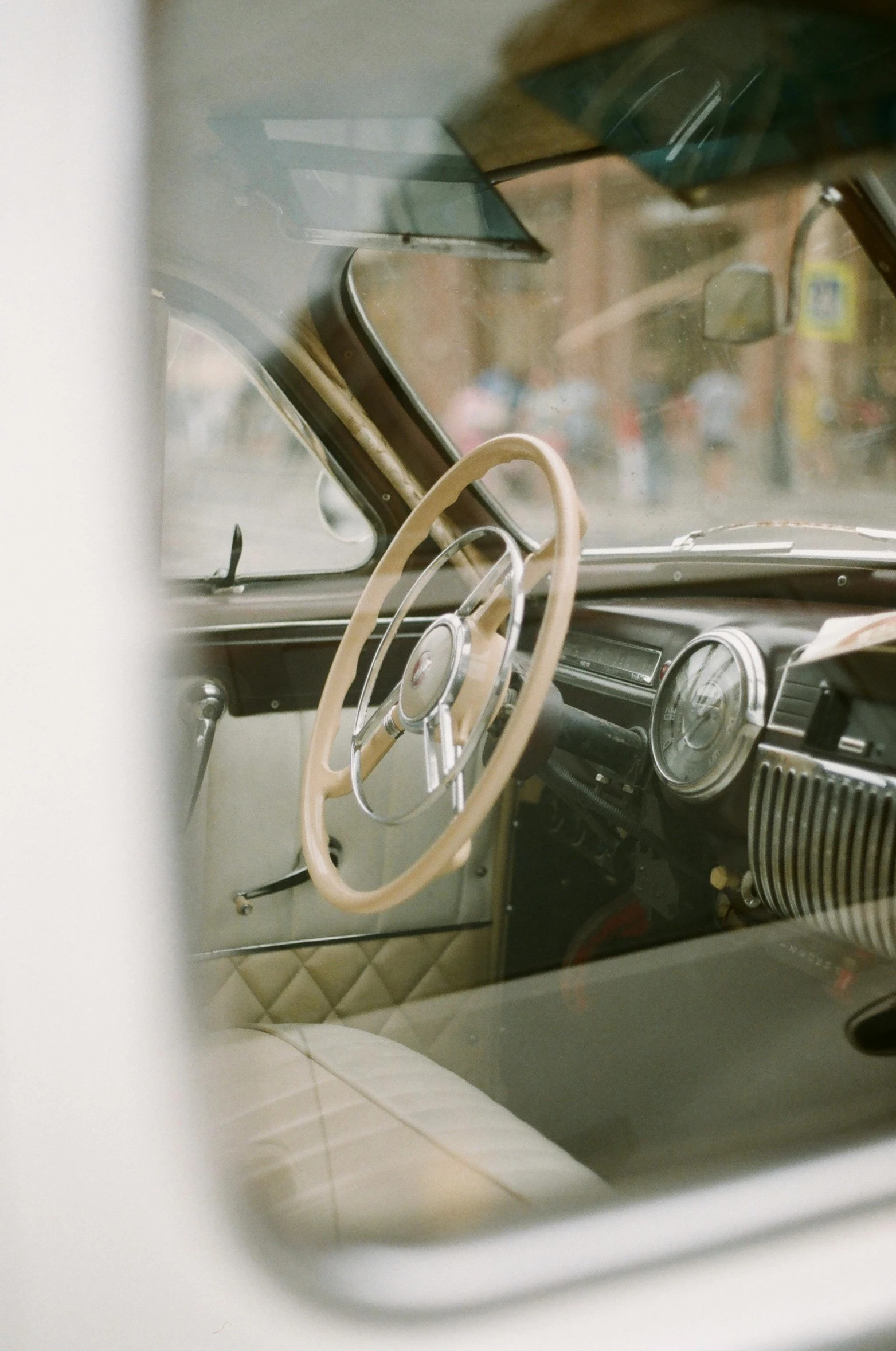 a close up of a car with a steering wheel, by Tom Bonson, trending on unsplash, modernism, vintage muted colors, historical photo, elegant interior, 3 / 4 wide shot