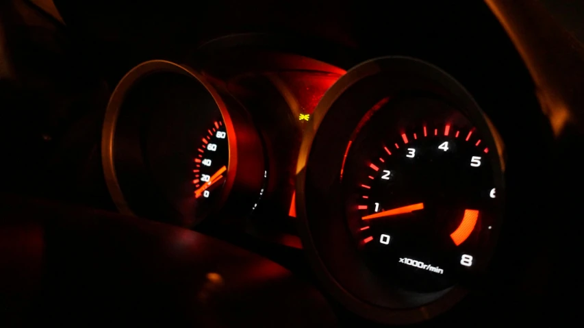 a close up of a speedometer in a car, a digital rendering, by Thomas Häfner, unsplash, red and orange glow, glowing engines, performance, taken in the late 2010s