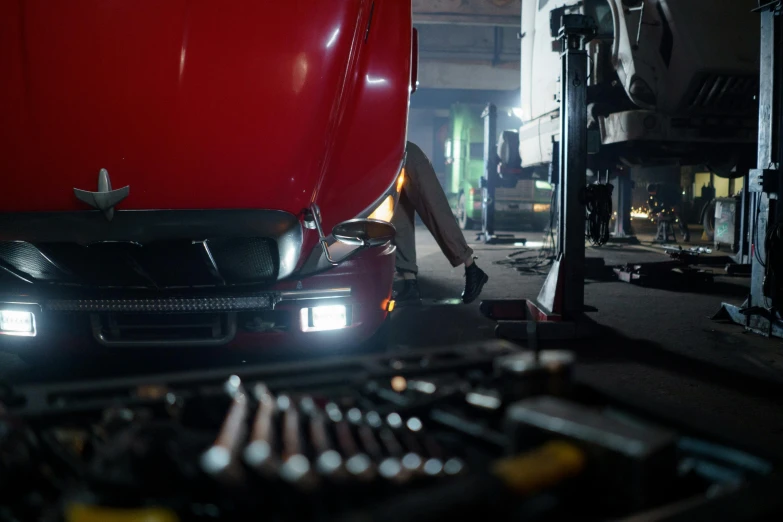 a close up of a car in a garage, by David Donaldson, cinematic lighting h 704, scene, led, mechanic