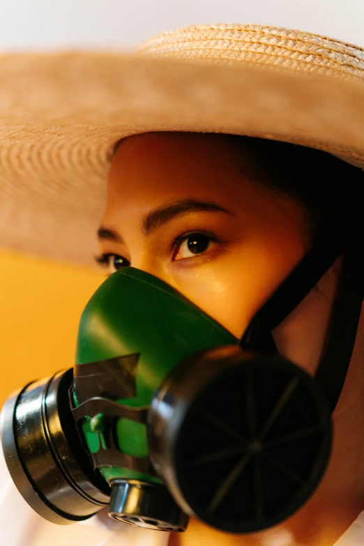 a woman wearing a hat and a gas mask, an album cover, inspired by Nan Goldin, pexels contest winner, green visor, mexico, mariko mori, movie still