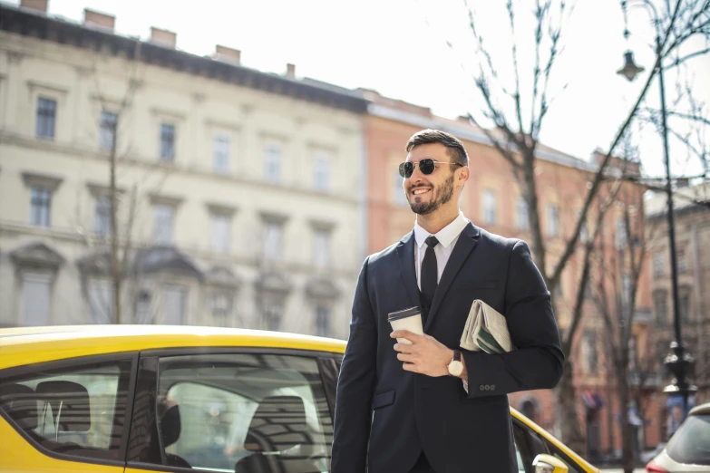a man in a suit and sunglasses standing in front of a yellow car, pexels contest winner, walking to work, avatar image, warsaw, group photo