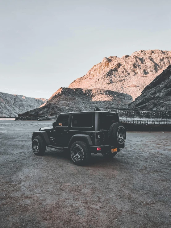 a jeep parked in front of a mountain, pexels contest winner, minimalism, black color scheme, profile image, cold top lighting, mid body shot