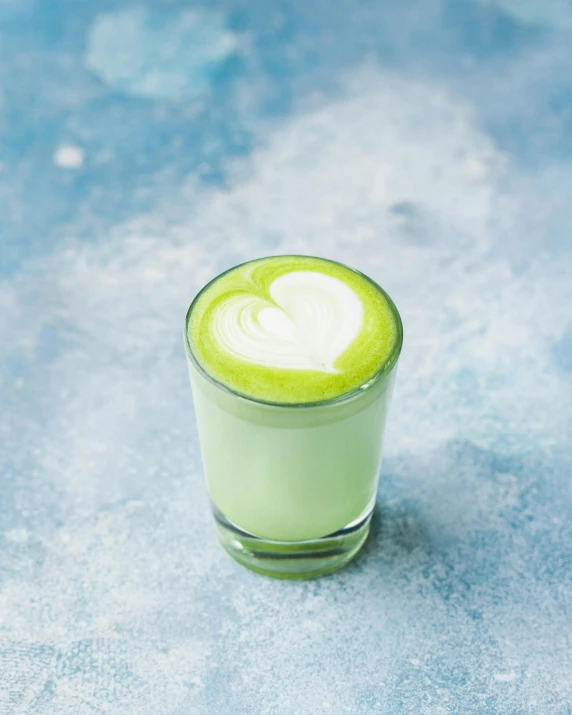 a green drink sitting on top of a table, soymilk, drinking their hearts out, square, no cropping