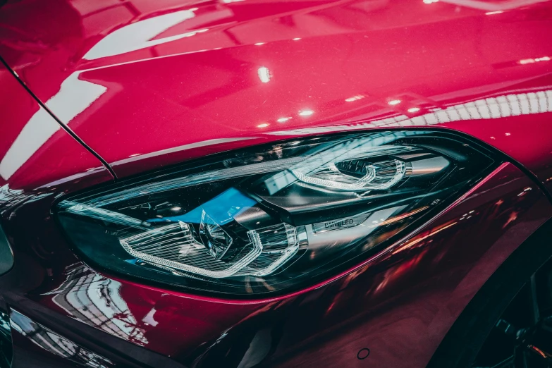 a close up of a red car's headlight, pexels contest winner, instagram post, glossy design, shot on sony a 7, car trading game