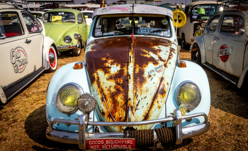 a group of old cars parked next to each other, by Lee Loughridge, pexels contest winner, auto-destructive art, horned beetle, brown, fair skin, enamel